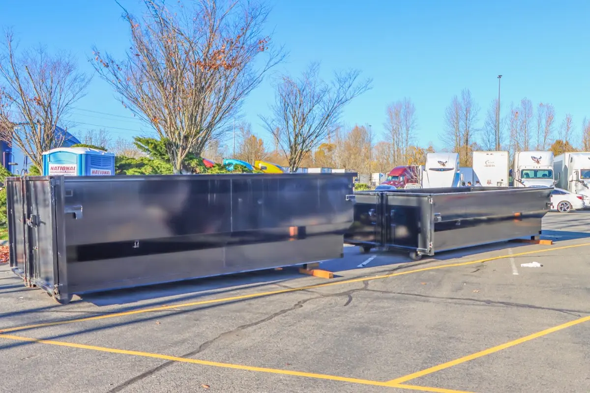 Professional dumpster rental service with roll-off container on residential driveway in Superior